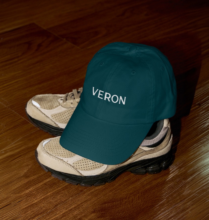Branded cap resting on trainers